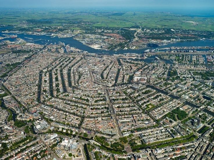 Aerial view of Amsterdam’s concentric canal belt and surrounding city